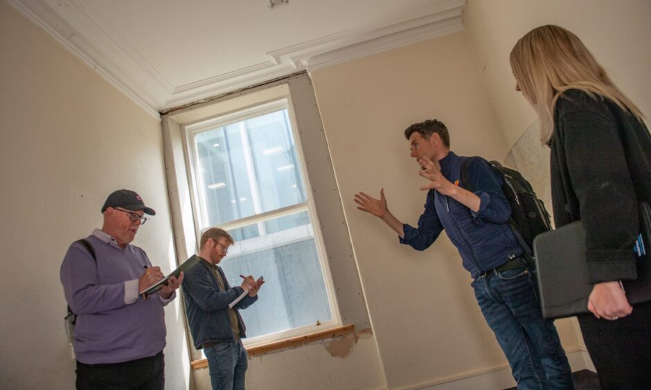 Richard Tinto paints his vision as the rest of the team scribble notes. Image: Kath Flannery/DC Thomson