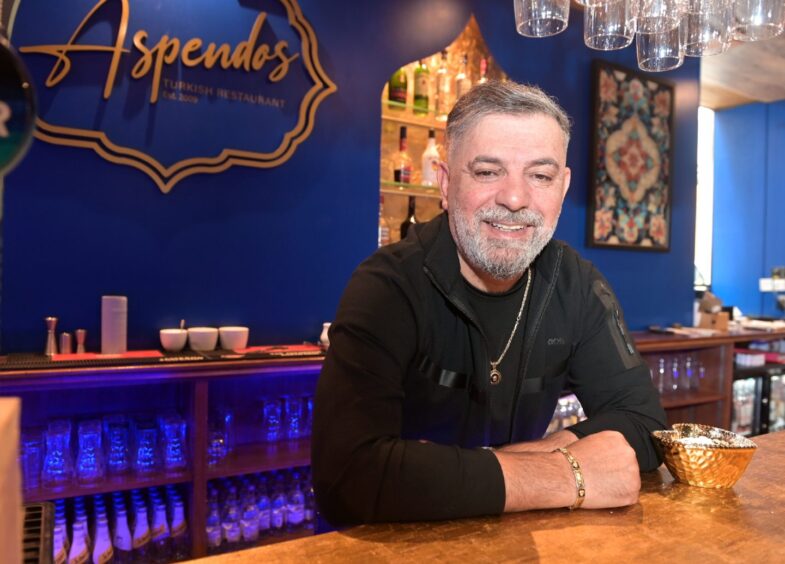 Partner and chef at Aspendos Inverness, Fahri Gulmez leaning against the bar.