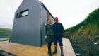 A man and a woman stand close together in front of their home which featured on Scotland's Home of the Year