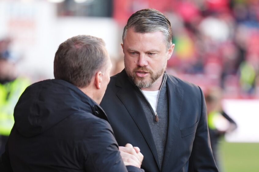 Aberdeen manager Jimmy Thelin (right) greets Celtic manager Brendan Rodgers. Image: PA.