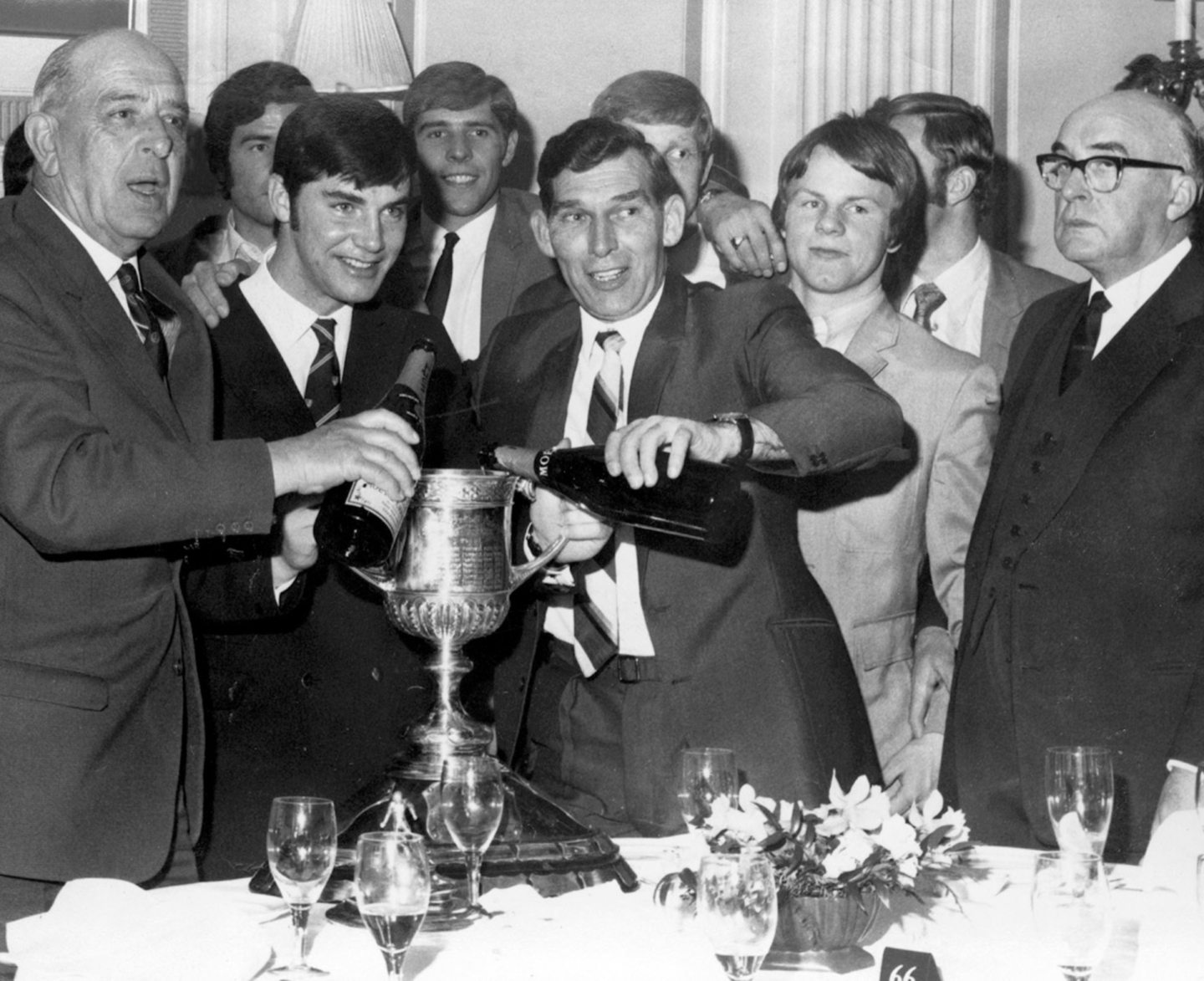 Manager Eddie Turnbull and Martin Buchan celebrates the Scottish Cup victory with players and officials. On the right is the Dons' chairman Dick Donald. 