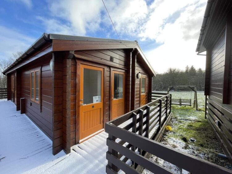 Log cabin surrounded by snow.