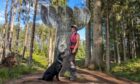 Gayle and her Labrador Dante pose beside this bizarre mirrored sculpture in Tyrebagger Wood near Aberdeen. Image: Gayle Ritchie.
