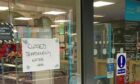 A sign on the Co-op store on Church Street, Inverness, about the water leak. Image: Supplied