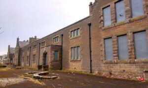 Facade of former Wick High School all boarded up