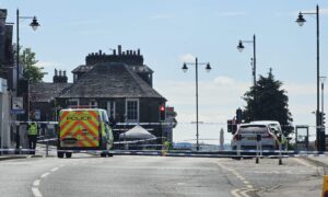 Castle Street remains cordoned-off, outside the Castle Tavern, as investigations continue. Image: DC Thomson.