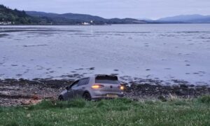 The car crashed onto the shoreline. Image: DC Thomson.