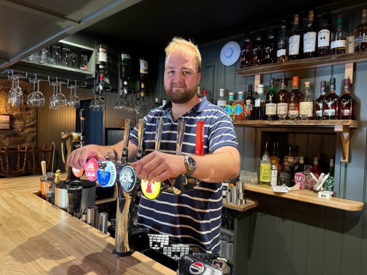 Jason Foster behind the bar in The Taynuilt Inn 
