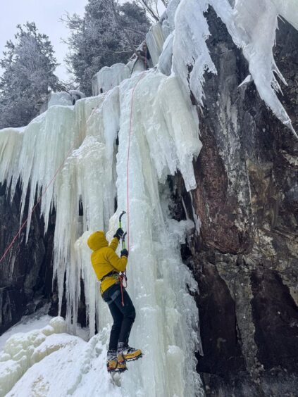 Steven Pollok climbing a frozen waterfall