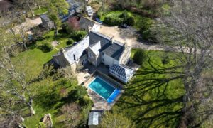 Cotfield Farmhouse with its pool in the back garden.