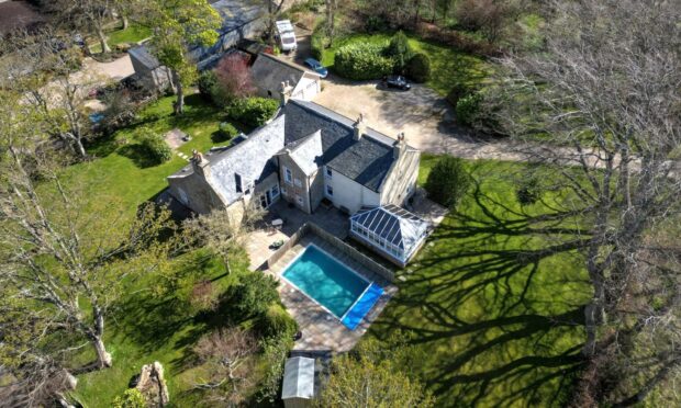 Cotfield Farmhouse with its pool in the back garden.