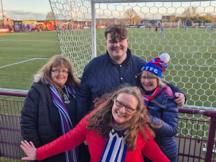 Inverness Caledonian Thistle fan Euan Bain, with Laura Grant, left, Liz MacRae, front, and Alison McInnes.