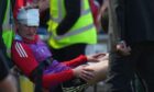 Aberdeen's Jack MacKenzie required treatment after being struck by a chair thrown from the stand following the Dons' 2-1 defeat by Dundee United. Image: Shutterstock