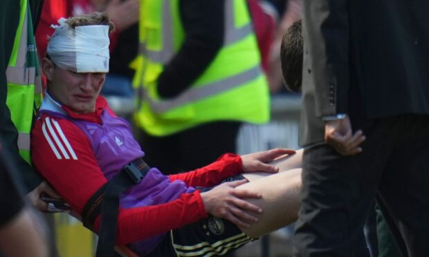 Aberdeen's Jack MacKenzie required treatment after being struck by a chair thrown from the stand following the Dons' 2-1 defeat by Dundee United. Image: Shutterstock