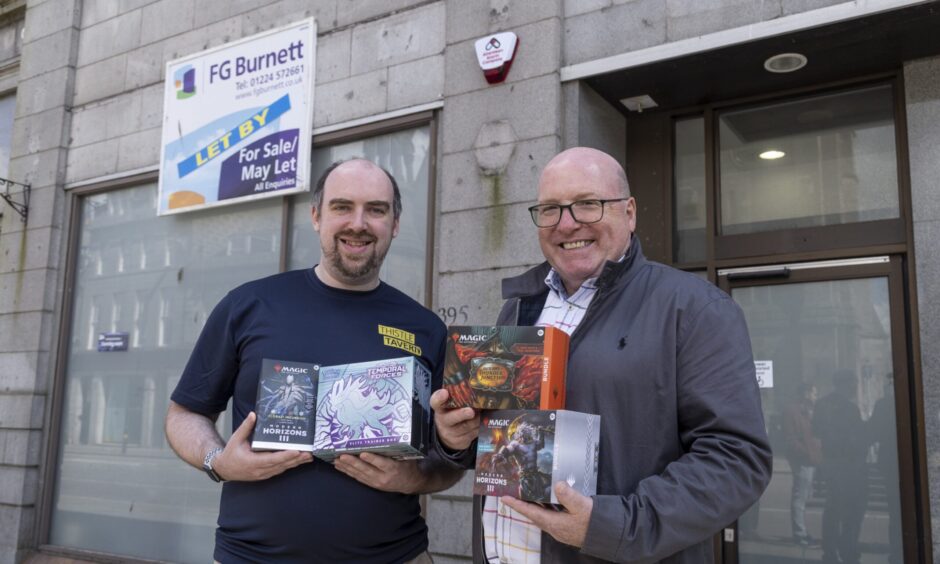 Stuart with Bob Keiler of Our Union Street outside Thistle Tavern holding Magic the Gathering decks