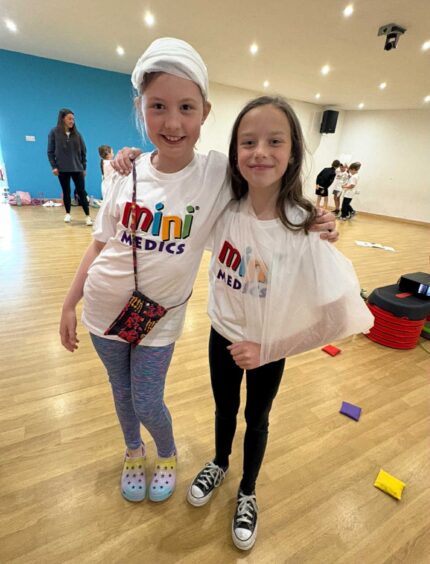 Two children in bandages at a Mini Medics course at the Happy Wee Health Club, Oban.