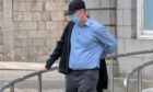 Andrew Dow hid his face from press cameras throughout the trial. Image: DC Thomson.