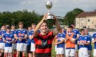 Oban Camanachd captain Daniel MacVicar lifts the Scottish Sea Farms Glasgow Celtic Society Cup. Image: Neil Paterson.