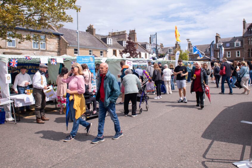 Crowds of people browsing the stalls at the Feein' Market in Stonehaven.