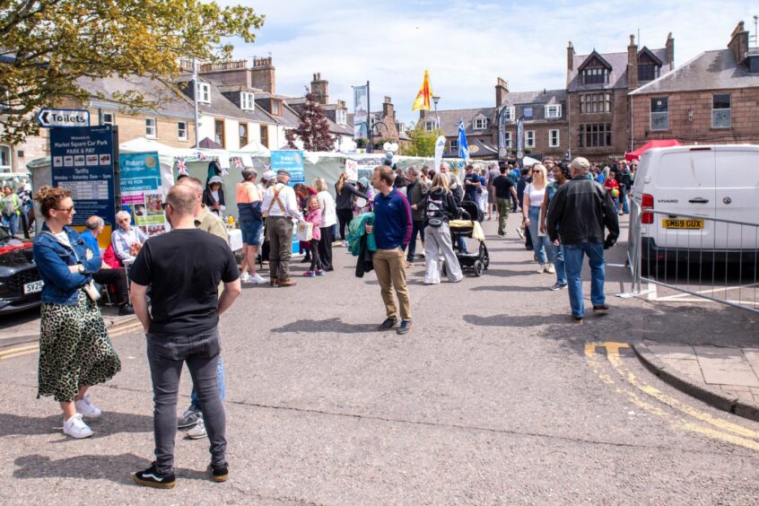 People looking around the attractions at the Feein' Market in Stonehaven.