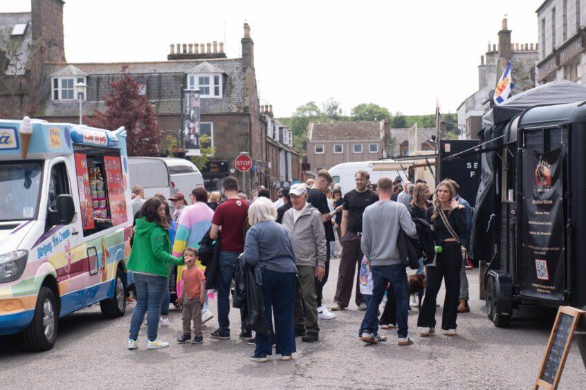 Crowds of people at the food vans.