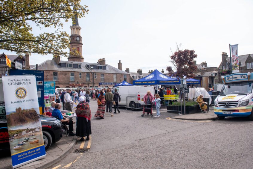 Picture shows the Feein' Market in Stonehaven, there's a sign saying "The Rotary Club of Stonehaven" and an ice-cream truck.