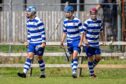 Newtonmore's strikeforce celebrate the late winner from Joe Coyle (centre). Image: Neil G Paterson.