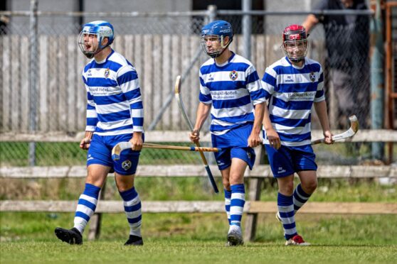 Newtonmore's strikeforce celebrate the late winner from Joe Coyle (centre). Image: Neil G Paterson.
