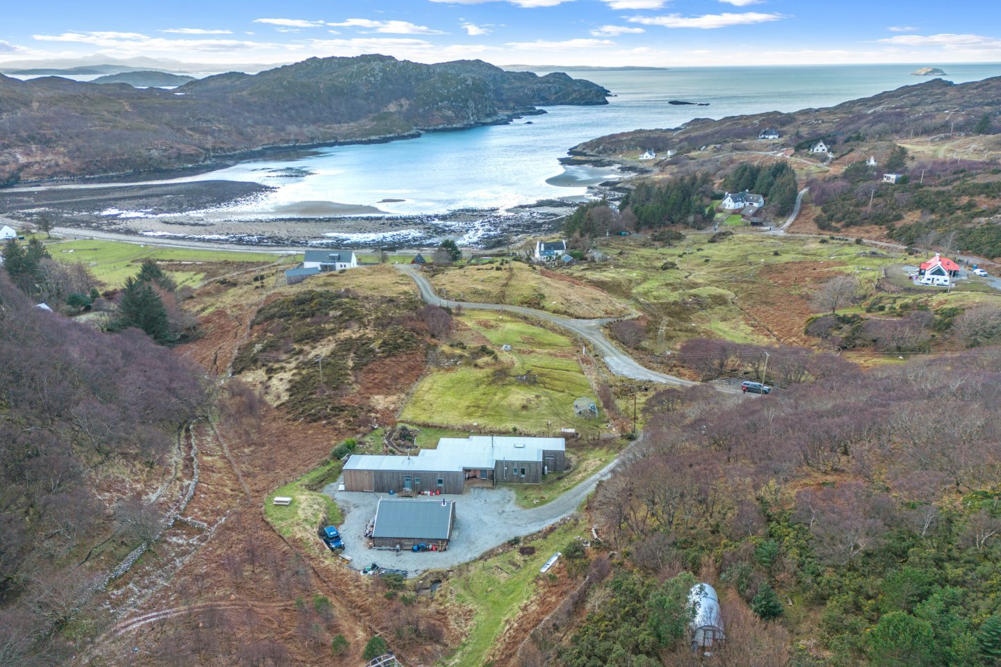 Aerial view of the house and surrounding landscape.