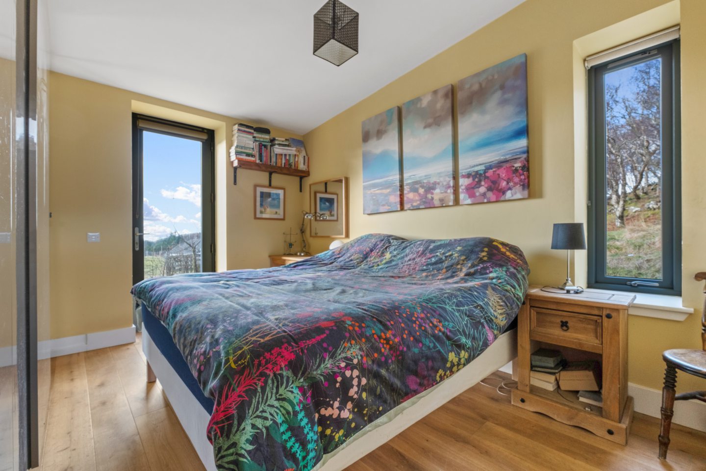 The soft yellow walls complement the natural landscape outside.