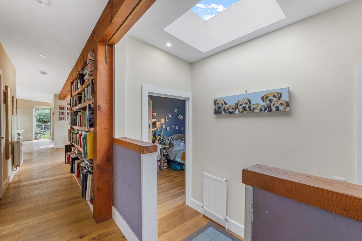 The home features wooden beams and a skylight.