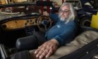 Dave Lyons in drivers seat looking over his shoulder.