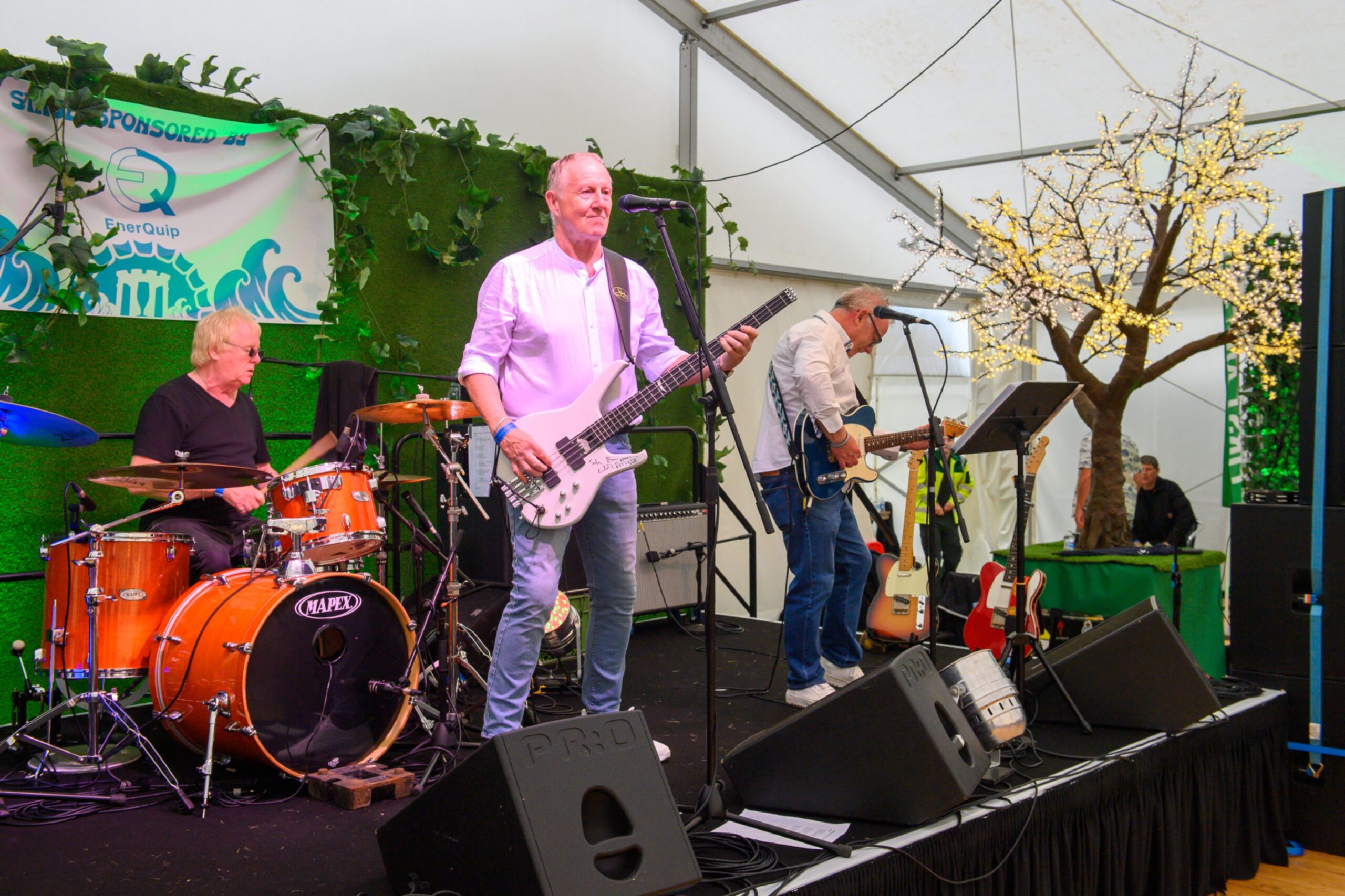 A band with drummer, lead singer and guitarist