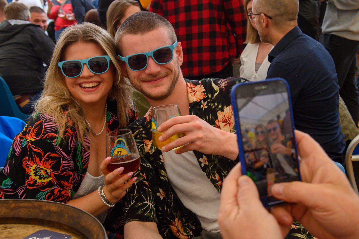 A man and woman smiling with beer
