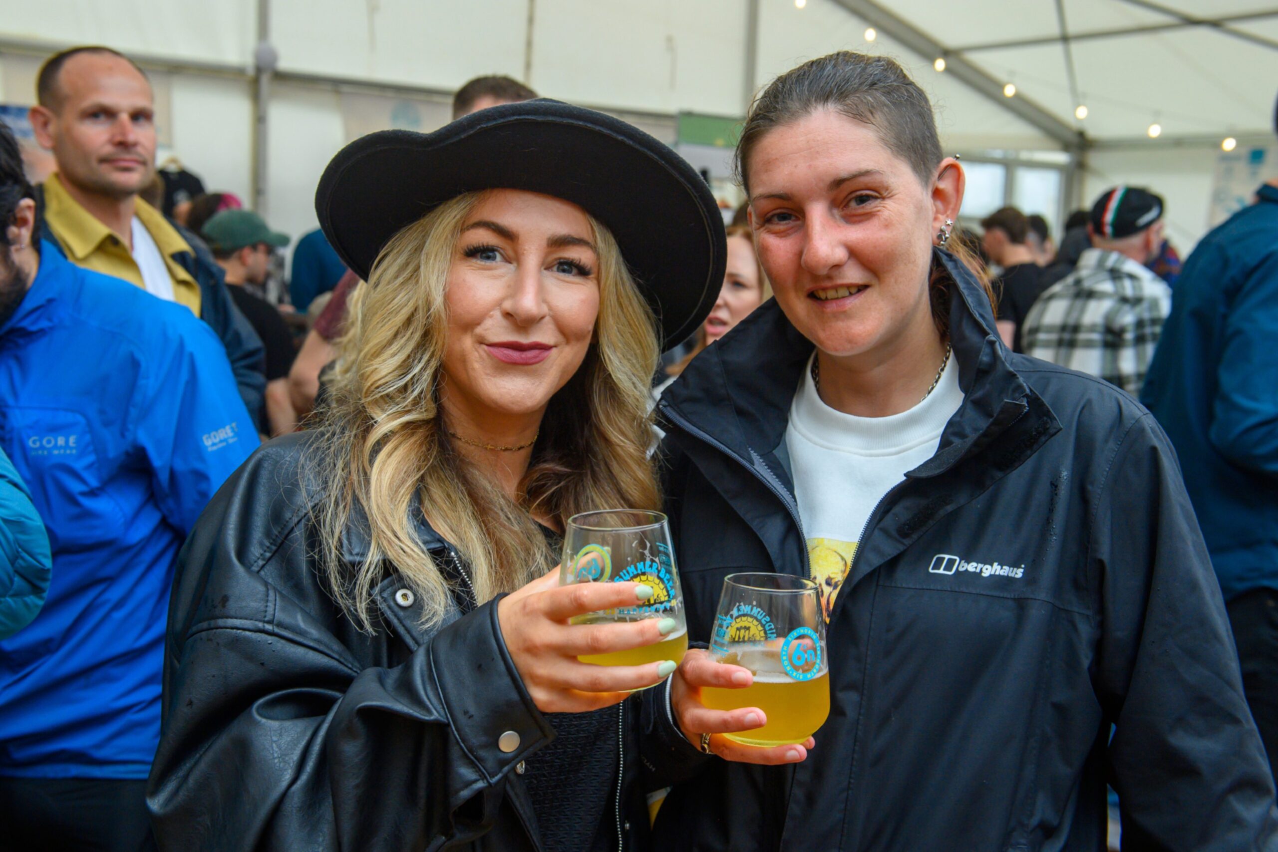 Two women pose with glasses of beer
