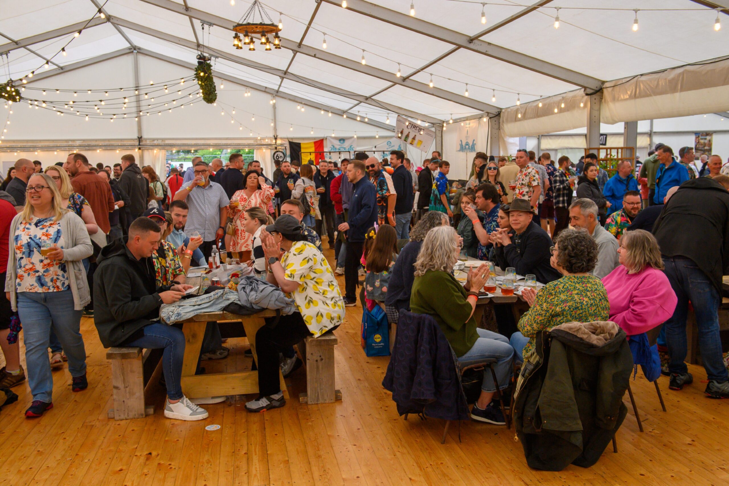 A large crowd fills a marquee