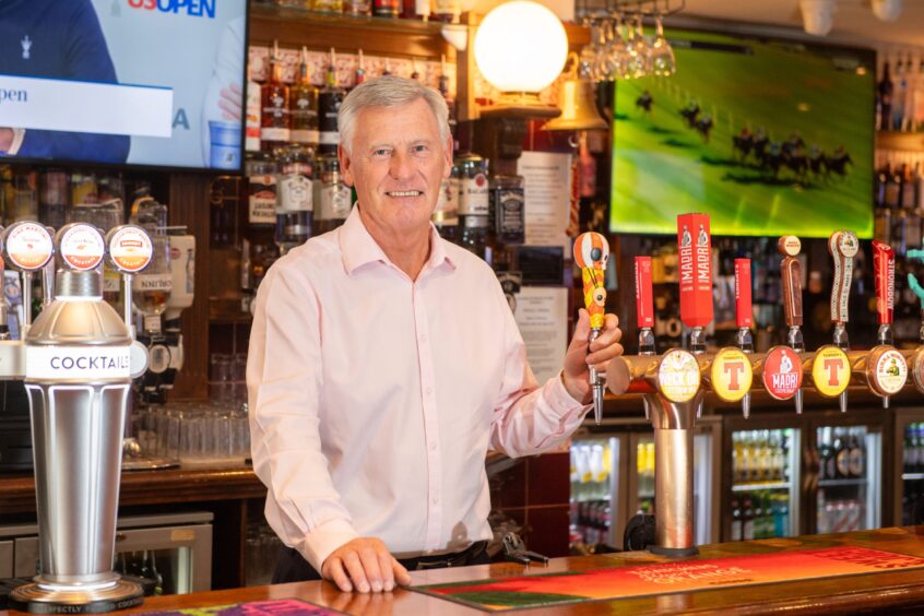 Stephen Taylor behind the bar at McNasty's. has invested over £1M converting the property above the bar into a hotel. Image: Kami Thomson/DC Thomson