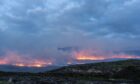 wildfires could be dowsed by heavy rain in the next few hours.