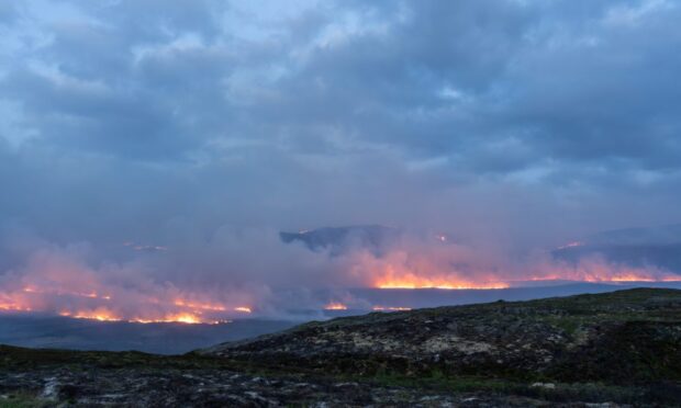 wildfires could be dowsed by heavy rain in the next few hours.