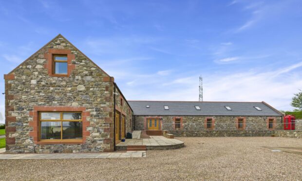 The gable end and side view of an L-shaped stonebuilt farmhouse