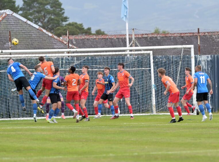 Strathspey Thistle's Jordan Laidlaw (No 4) heads the ball into the Inverness box during a pre-season friendly at Seafield Park, Grantown, on June 21, 2025.