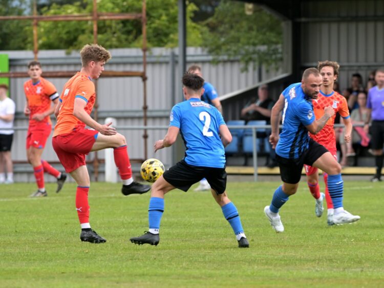 Sam Reid, of Caley Thistle, on the ball against Strathspey's Filip Franczak in a pre-season friendly at Seafield Park, Grantown, on June 21, 2025.