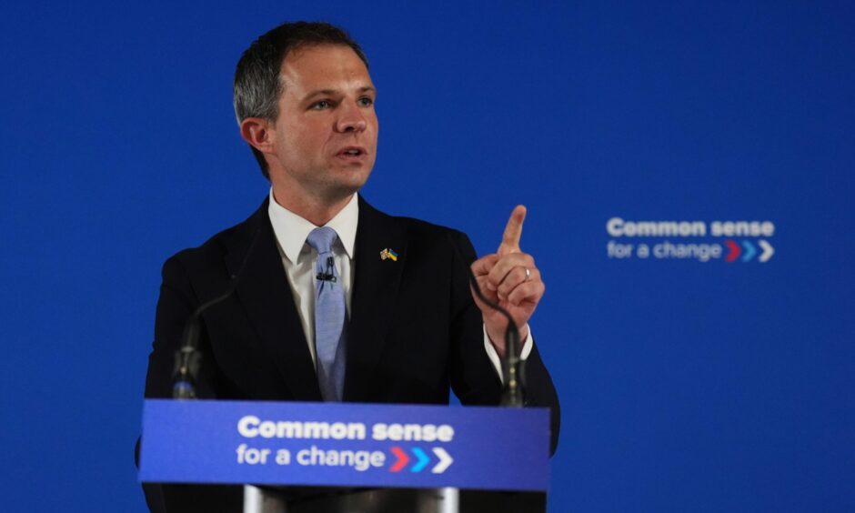 Andrew Bowie speaking at podium.