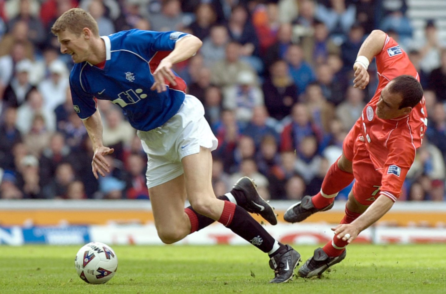 Rangers' Tore Andre Flo and Aberdeen's Roberto Bisconti take a tumble during a league clash at Ibrox. 