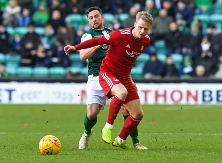 Gary Mackay-Steven, front, playing for Aberdeen against Hibernian's Lewis Stevenson in the SPFL Premiership on February 2, 2019 at Easter Road Stadium, Edinburgh. 