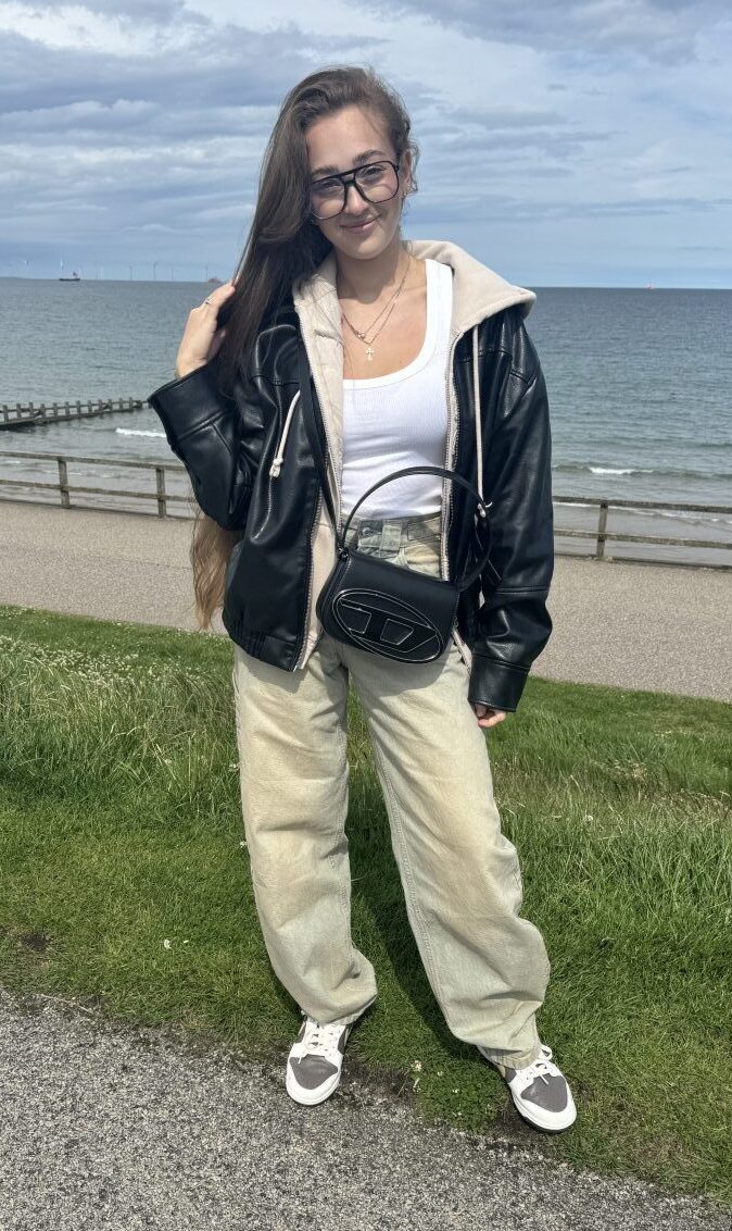 Anastasiia Slobozhaninova wearing pale green trousers and a black fleece-lined hoodie