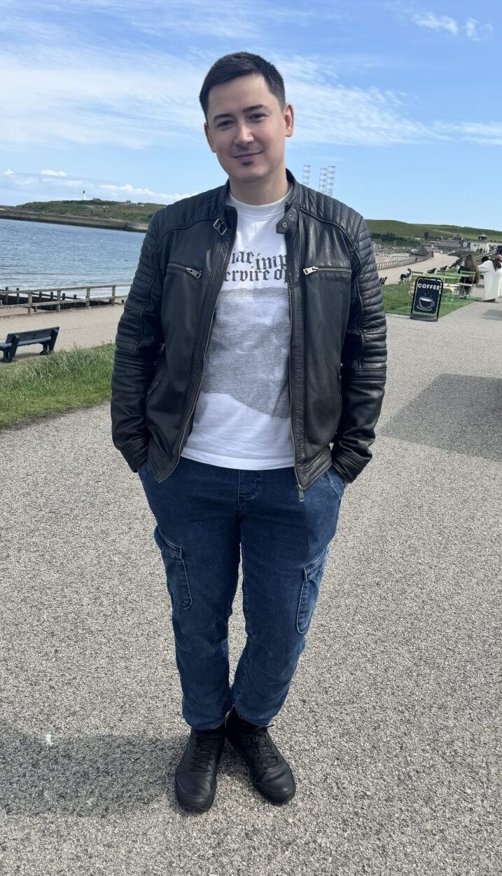 Catalin Dragu talks us through his outfit which consists of blue jeans, a graphic t-shirt and a black leather jacket