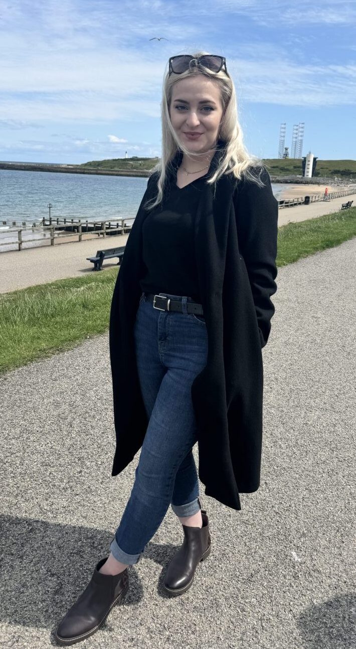 Cristina Dragu at Aberdeen beach talks us through her style, which features blue jeans, black boots and a black coat