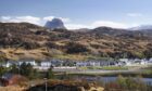 The picturesque community of Lochinver, with Suilven behind.