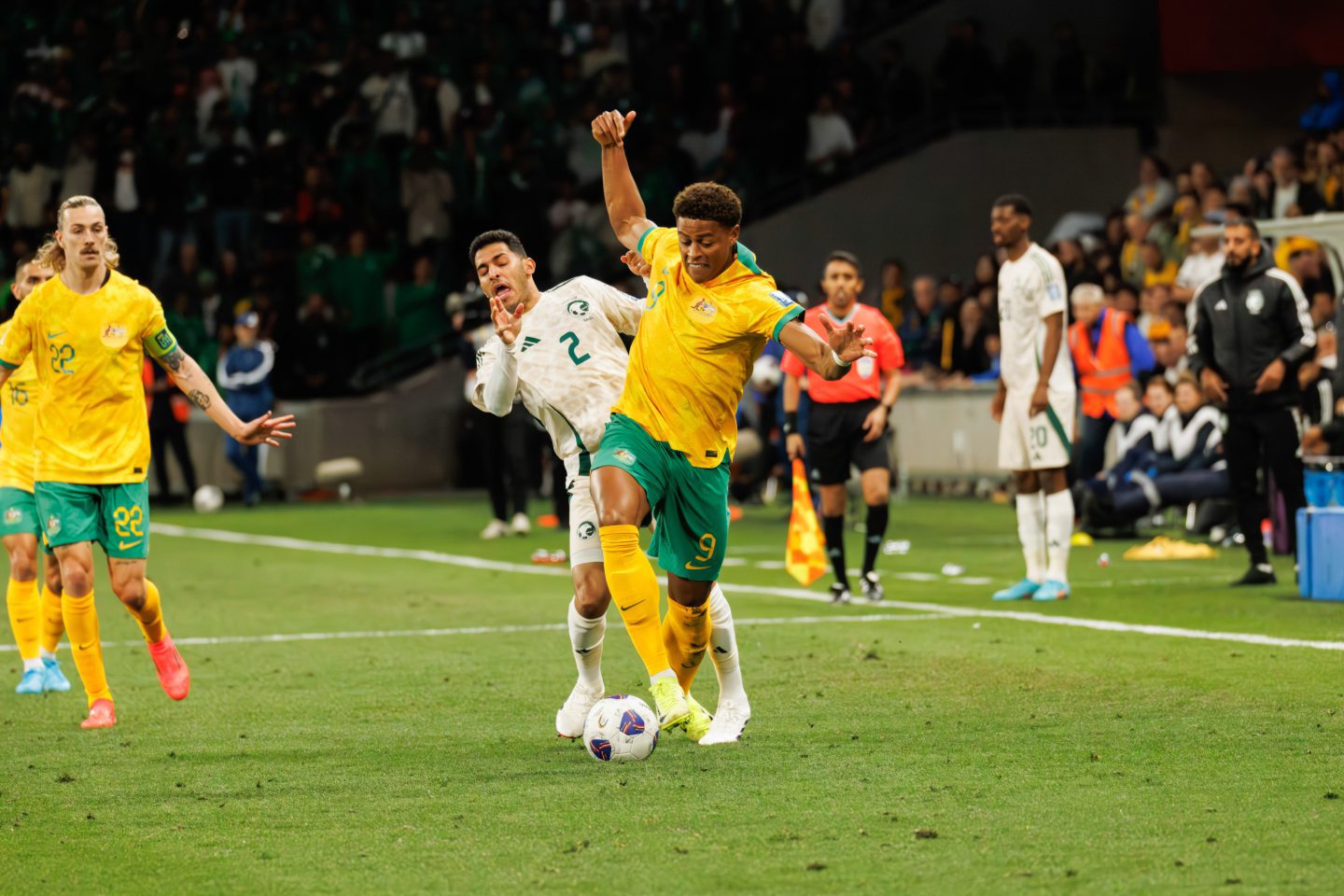 New Aberdeen signing Kusini Yengi in action for Australia (R) against Sultan Al Ghannam of Saudi Arabia during a FIFA World Cup 2026 Qualifier match.